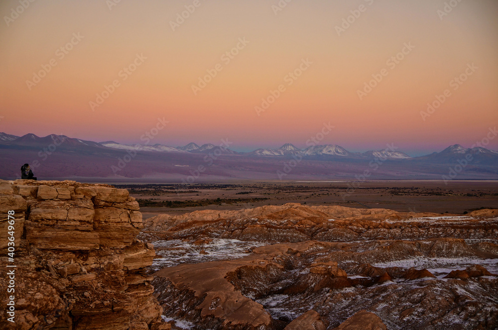 Woman admiring the sunset view of the Moon Valley in the Atacama Desert, Antofagasta, Chile