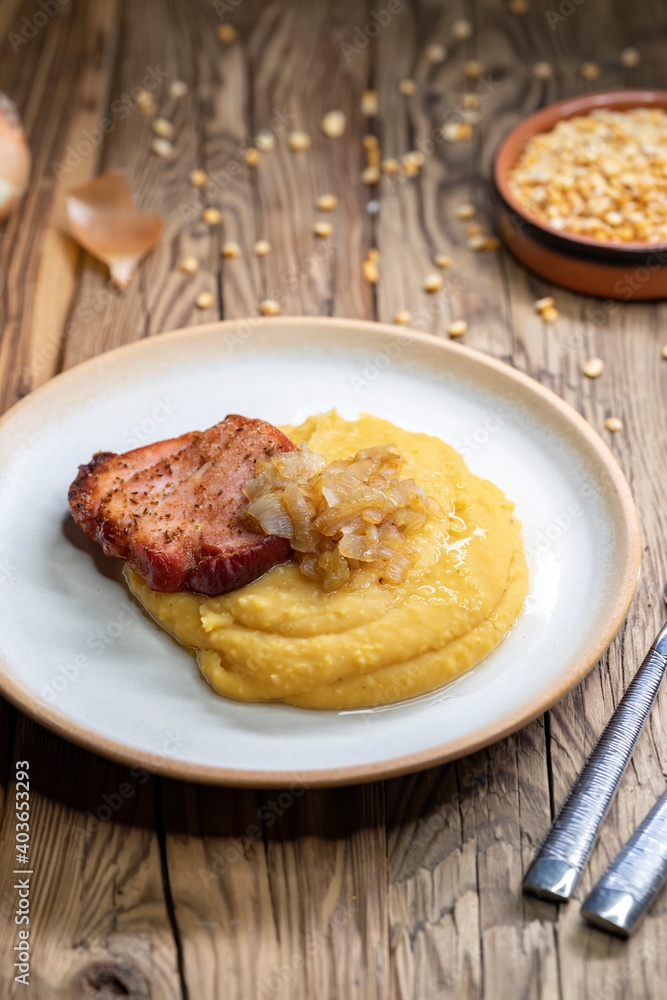 Czech cuisine, smoked meat with pea porridge and fried onion until golden Czech cuisine, smoked meat with pea porridge and fried onion until golden