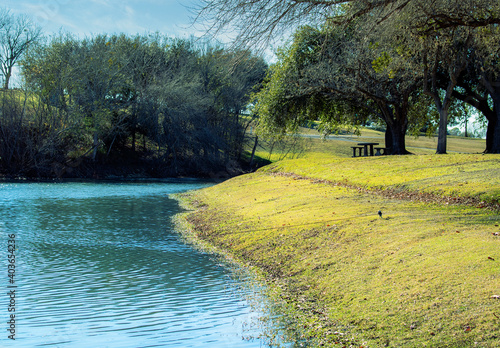 Vászonkép picnic area next to a stream that runs through a public park in Shiner, TX