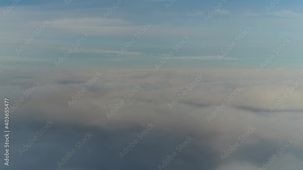Aerial cockpit view flight above clouds showing the aerosol consisting of a visible mass of minute liquid droplets and above this a beautiful crisp blue sky 4k high resoltuion footage quality Aerial cockpit view flight above clouds showing the aerosol consisting of a visible mass of minute liquid droplets and above this a beautiful crisp blue sky 4k high resoltuion footage quality