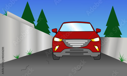 Vorderansicht eines rotes Autos auf einer engen Straße neben grauen Wänden und im Hintergrund grüne Tränen und blauer Himmel