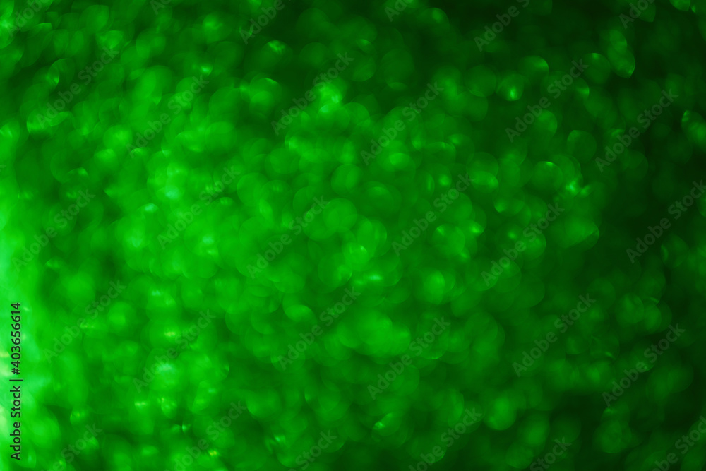 Blurred defocused background. Texture of green black bokeh. Template for St. Patrick's Christmas holiday greeting cards. Abstraction template. Copy space Layout for decoration Blurred defocused background. Texture of green black bokeh. Template for St. Patrick's Christmas holiday greeting cards. Abstraction template. Copy space Layout for decoration