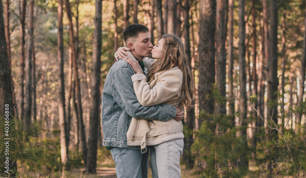 the guy hugs the girl tightly and kisses her while in the pine forest
the guy hugs the girl tightly and kisses her while in the pine forest
