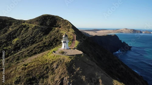 Aerial pull back of Cape Reinga Lighthouse. Outstanding panoramic view of New Zealand coastline. photo