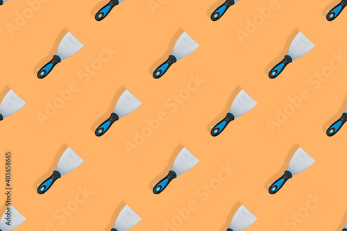 Putty trowel seamless pattern. Spatulas for on an orange background.