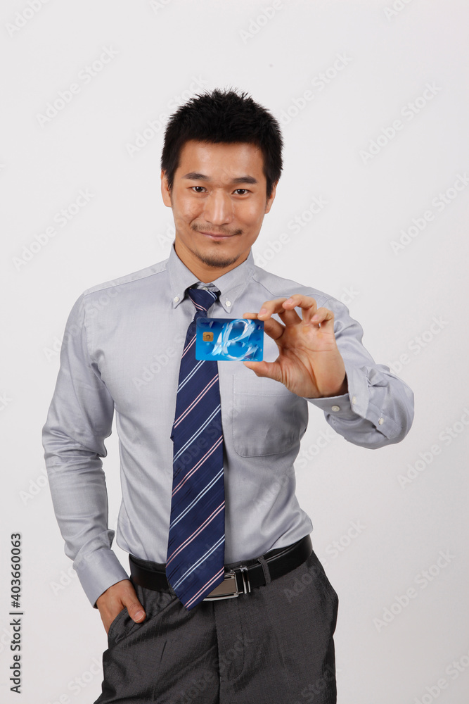 A young business man with a bank card A young business man with a bank card