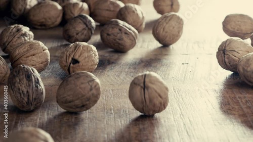 Rolling walnuts on wooden table