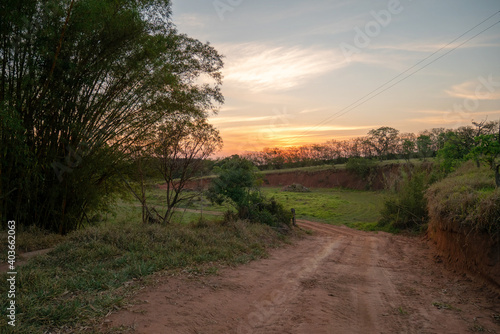 View of dirt road inland at sunset