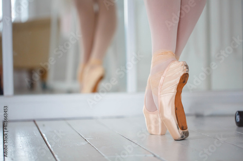 Legs of beauty ballerina standing in pink pointe shoes. Close-up