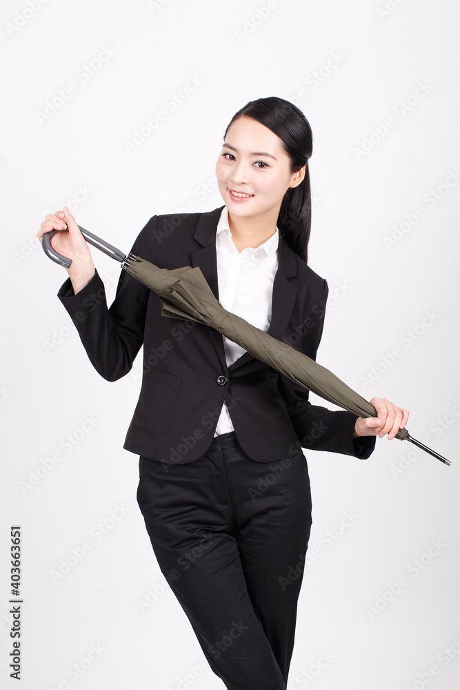 A young business woman holding an umbrella A young business woman holding an umbrella