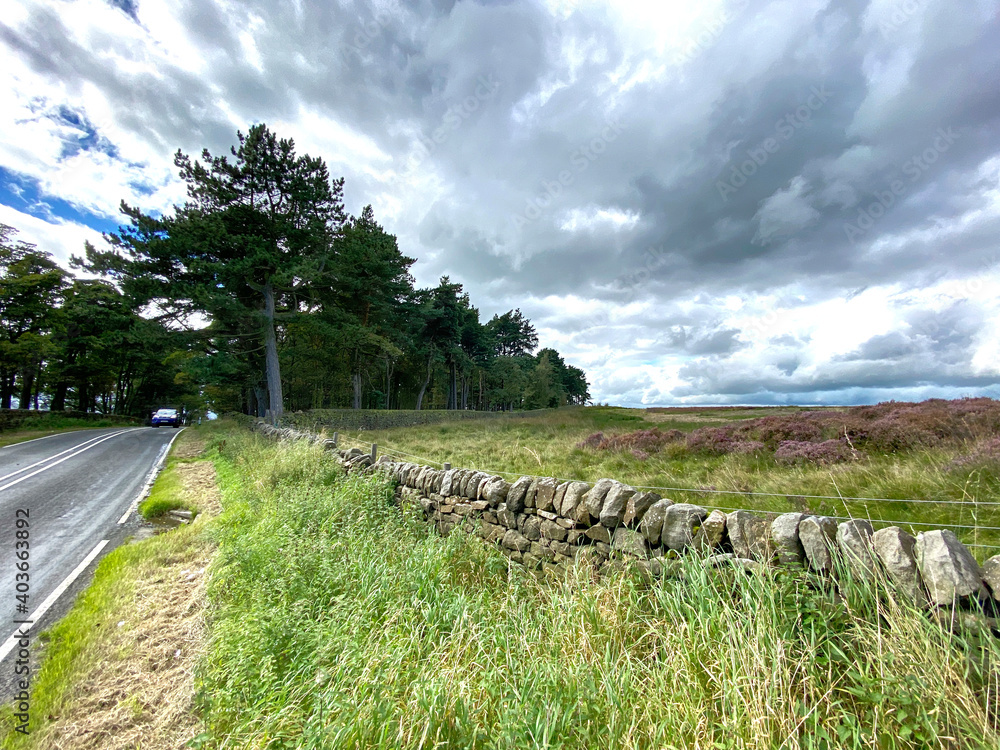 Fototapeta premium Moor top view, next to, Otley Road, with heavy clouds above near, Bingley, Bradford, UK