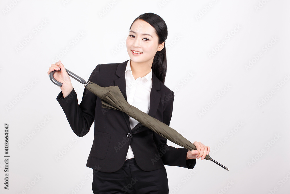 A young business woman holding an umbrella A young business woman holding an umbrella
