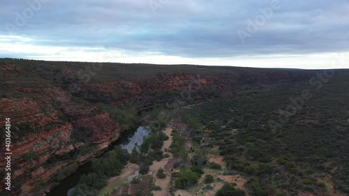 Sweeping drone view of the Murchison River meandering through red sandstone gorges in Kalbarri National Park, Western Australia photo