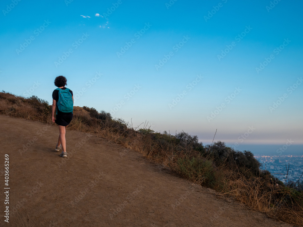 View of girl alone doing mountain hike