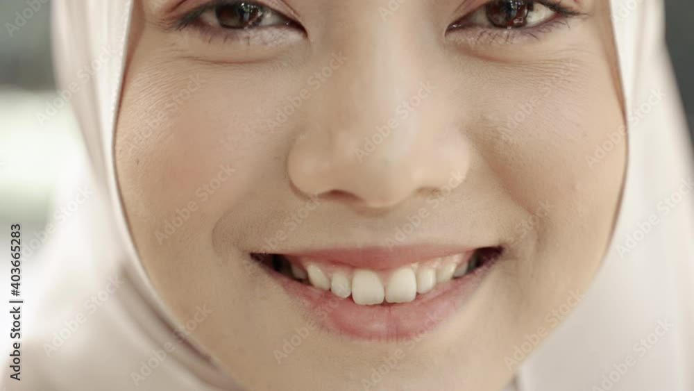 Close-up video, a smiling Muslim woman's face
Close-up video, a smiling Muslim woman's face