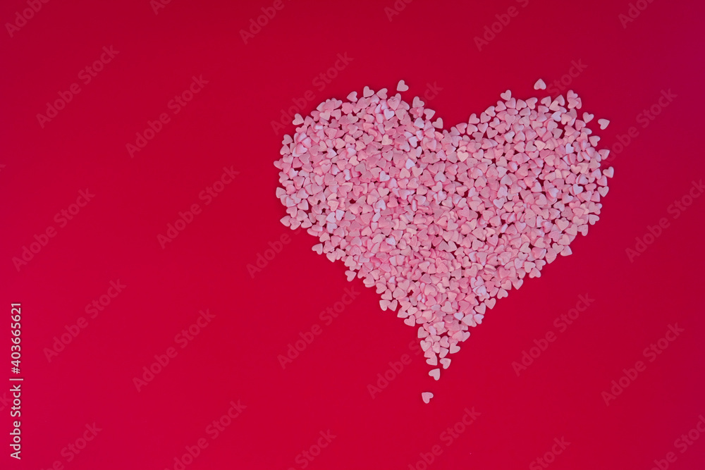 Big heart made of small hearts on red background. Love, wedding and happy valentine minimal concept. Copy space