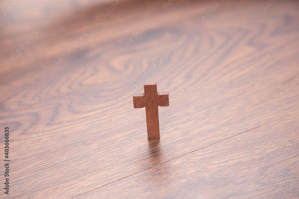 wooden cross on the wooden background