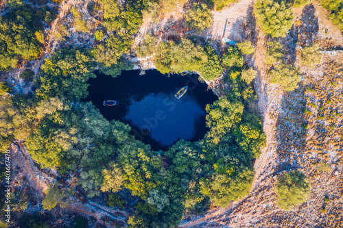 Famous Melissani lake on Kefalonia island, Karavomylos, Greece. On top of Melissani Cave (Melissani Lake) in Karavomylos village in Kefalonia island , Greece. Melissani Cave viewed from above. photo