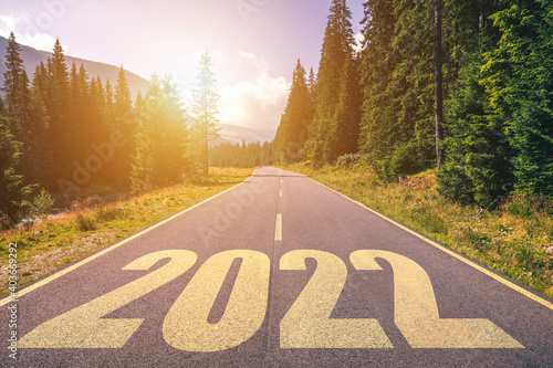 Empty asphalt road and New year 2022 concept. Driving on an empty road in the mountains to upcoming 2022. Concept for success and passing time.