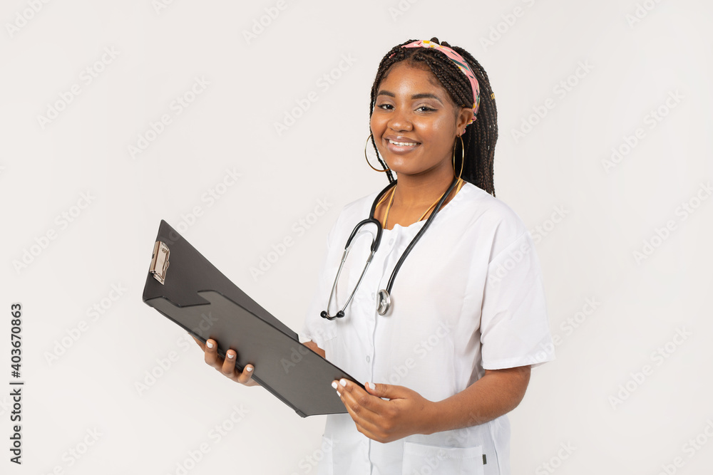 beautiful young african female on a white background in a medical gown with a folder beautiful young african female on a white background in a medical gown with a folder