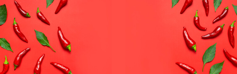 Frame made of Hot red and green fresh chili peppers on red background flat lay top view. Seasoning for dish, spicy spices for cooking, cayenne pepper, food. Creative layout, chili pattern. Banner