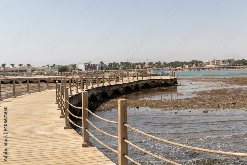 Hurghada, Egypt - September 29 2020: View of the wooden boardwalk over the Red Sea in Hurghada, Egypt Hurghada, Egypt - September 29 2020: View of the wooden boardwalk over the Red Sea in Hurghada, Egypt