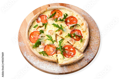 Whole seafood Pizza with cocktail prawns, tomato slices, cream sauce served with fresh arugula Leaves on wooden plate served with culinary flour and spices, isolated on white background 