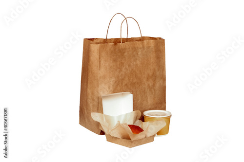 Fast food eco packaging with big lunch set of tasty hamburger, brown paper bag and box on the table isolated on white background