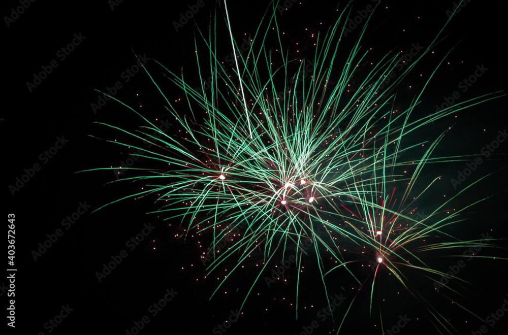 Coloured firework exploding at a fireworks display. Coloured firework exploding at a fireworks display.