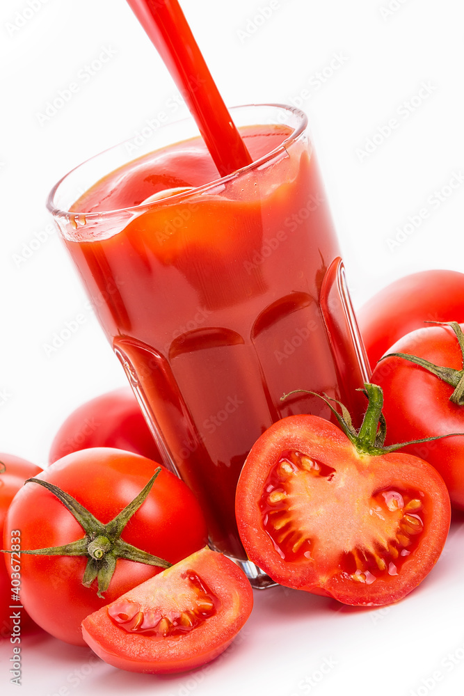 Tomato juice in a glass and tomatoes with green sepals Tomato juice in a glass and tomatoes with green sepals