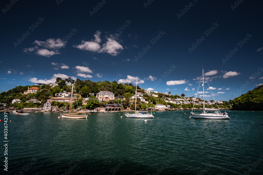 Sailboats on the Yealm at Noss Mayo during a bright summer day.