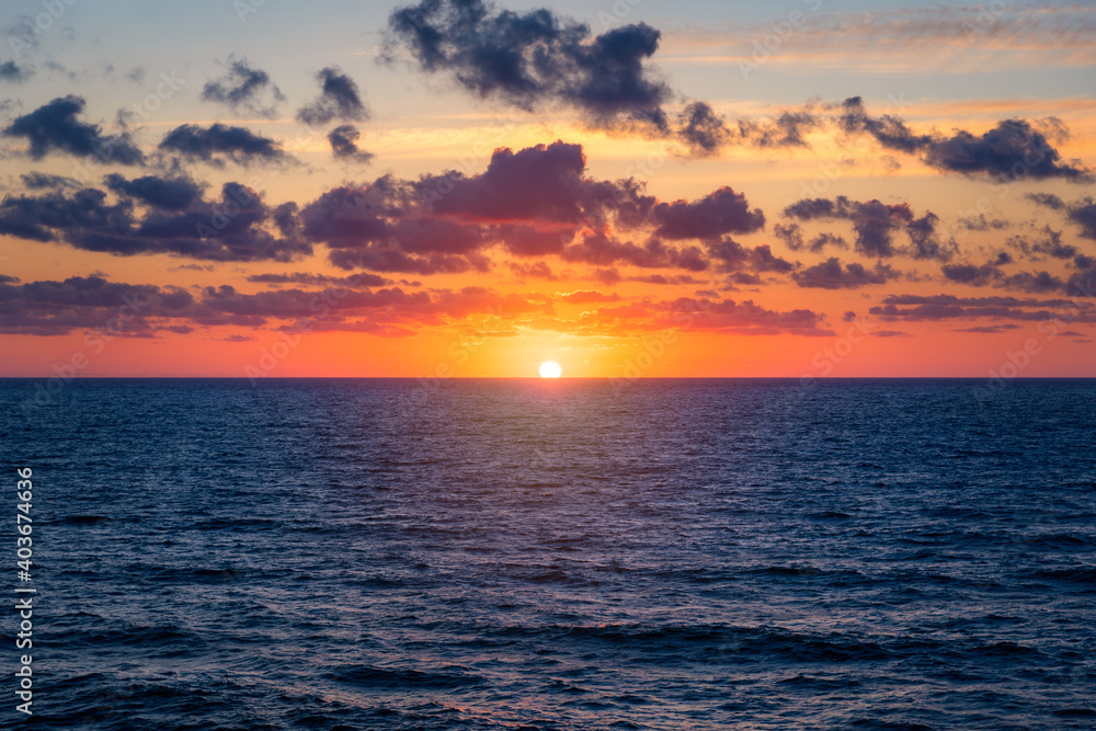 Beautiful sunset/sunrise over the sea. Beautiful sunset over the ocean. Beautiful sunset over sea with reflection in water, majestic clouds in the sky Beautiful sunset/sunrise over the sea. Beautiful sunset over the ocean. Beautiful sunset over sea with reflection in water, majestic clouds in the sky