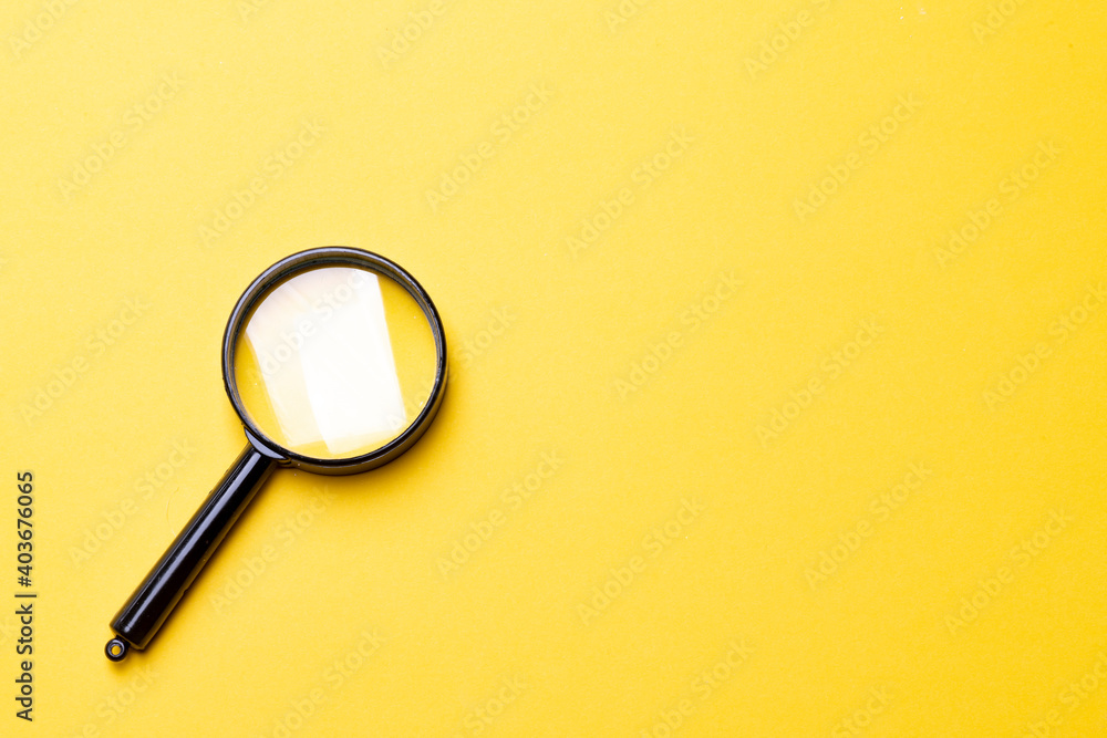 Black magnifier on a yellow background. Black magnifier on a yellow background.