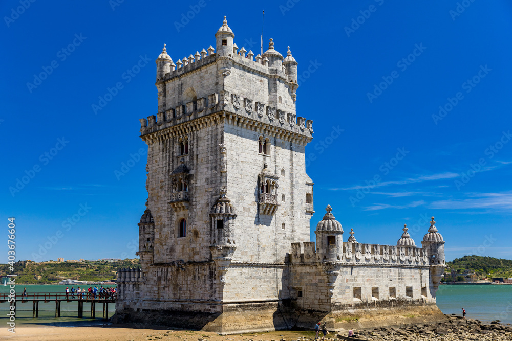 View at the Belem tower at the bank of Tejo River in Lisbon, Portugal. The Belem Tower (Torre de Belem), Lisbon, Portugal. At the margins of the Tejo river, it is an iconic site of the city.