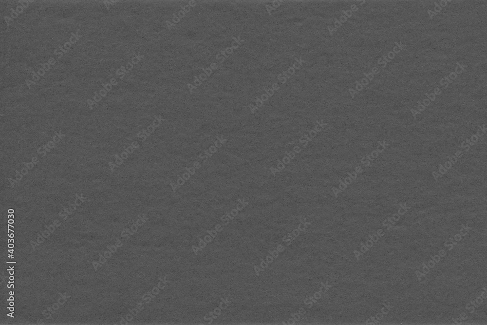 Fototapeta premium Cardboard black abstract texture close-up. Dark old paper background. Grunge concrete wall. Vintage blank wallpaper.