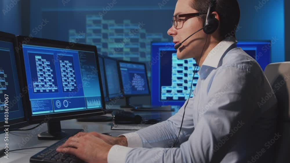 Call-center worker is speaking with the client by headset. Workplace of the support operator. Call-center worker is speaking with the client by headset. Workplace of the support operator.