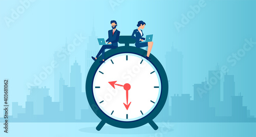 Vector of a business man and businesswoman using  laptop sitting on a clock working long hours