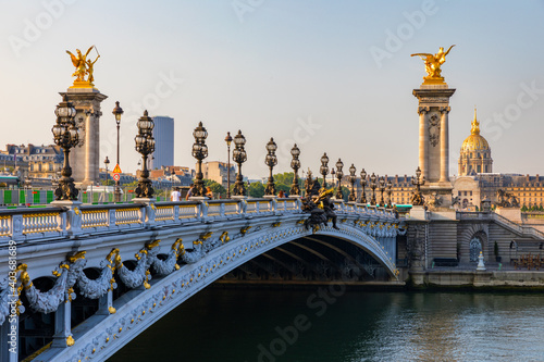 Pont Alexandre III bridge over river Seine in the sunny summer morning. Bridge decorated with ornate Art Nouveau lamps and sculptures. The Alexander III Bridge across Seine river in Paris, France. © daliu