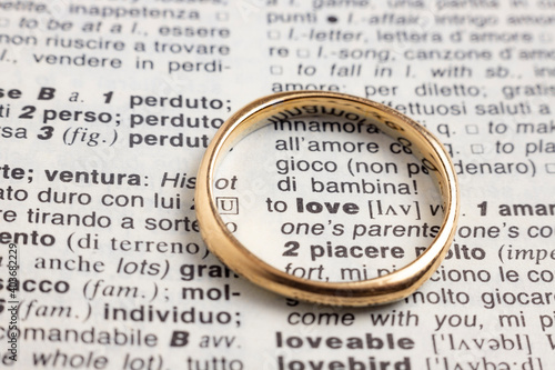 wedding ring on the word love of a vocabulary
