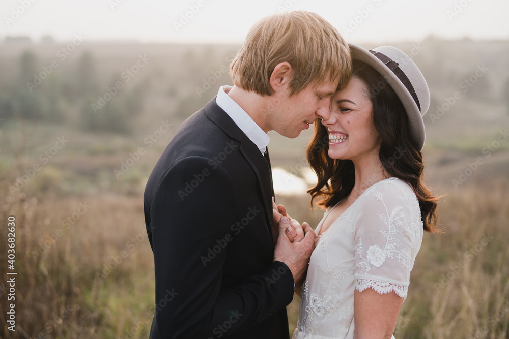 Romantic, young and happy caucasian couple in wedding clothes on the background of beautiful nature. Love, relationships, romance, happiness concept. Bride and groom traveling  together.