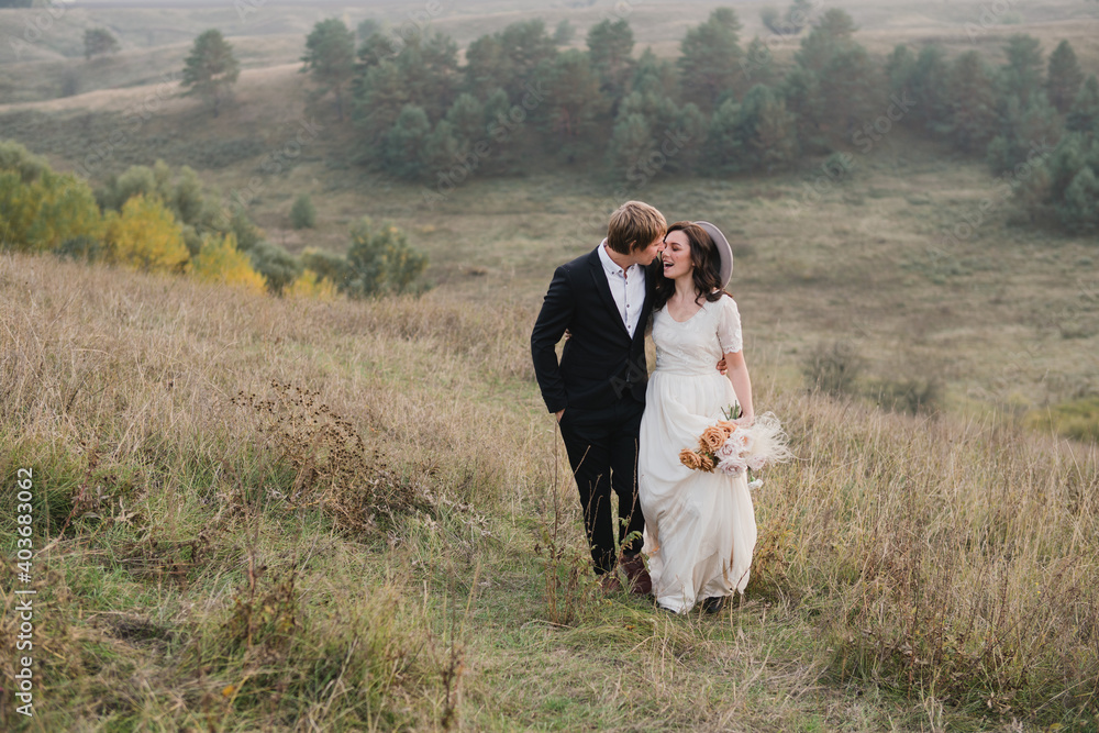 Romantic, young and happy caucasian couple in wedding clothes on the background of beautiful nature. Love, relationships, romance, happiness concept. Bride and groom traveling together. Romantic, young and happy caucasian couple in wedding clothes on the background of beautiful nature. Love, relationships, romance, happiness concept. Bride and groom traveling together.
