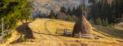 Haystack near a dirt road in the mountains photo