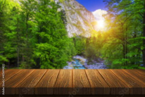 Empty wooden table in front of abstract blurred background in nature  can be used for display or montage your products. Mock up for display of product