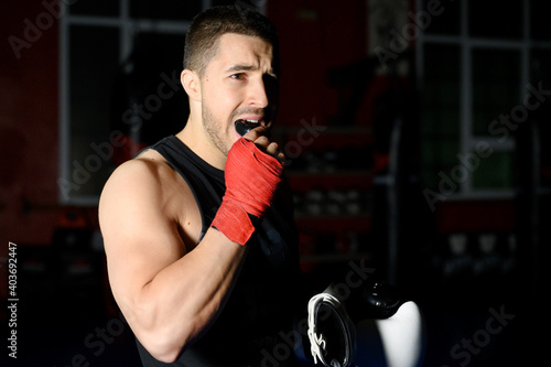 Boxing fighter putting on mouthguard. High quality photo photo
