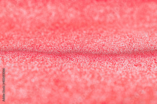 Pink gold. Christmas glitter red background with bright sparkle bokeh texture for xmas shine silver pattern. Blurred vintage lights with copy space. Defocused.