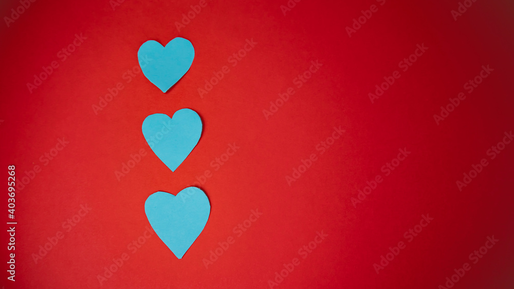 Valentine's Day. Blue hearts on a red background.