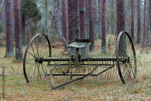 Obraz na plátně Vintage metal farm machinery in the forest