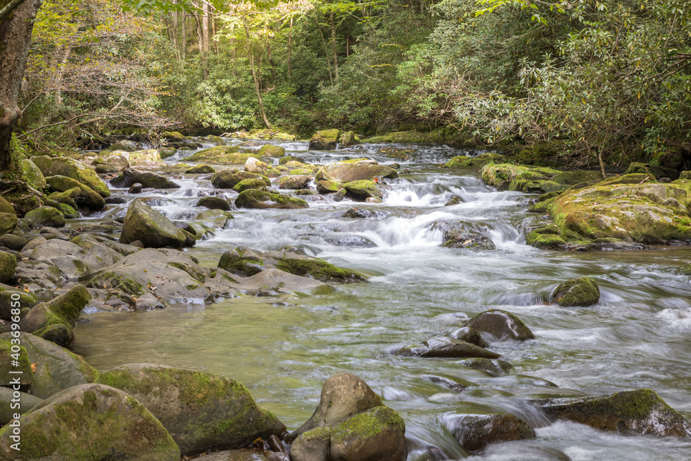 A calm shallow river flowing through the Smoky Mountains A calm shallow river flowing through the Smoky Mountains