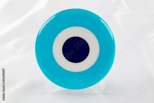 Glass Turkish eye on white background Evil eye amulet protect from bad things using by turkish culture. photo