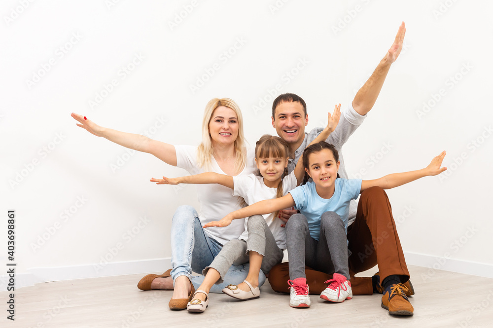 Smiling young parents and their children are very happy, they are at home Smiling young parents and their children are very happy, they are at home
